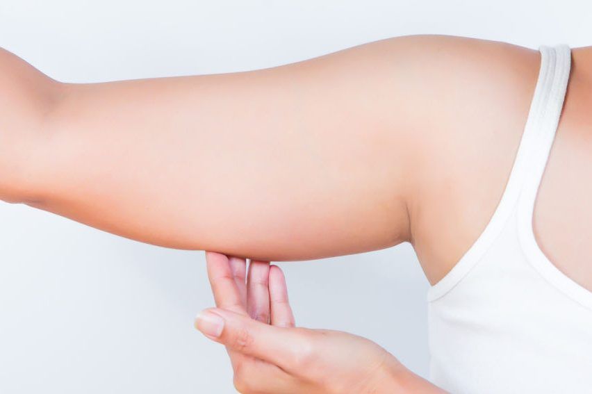 asian woman showing her fat upper arm